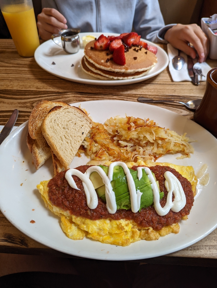 An American breakfast with omelette and pancakes