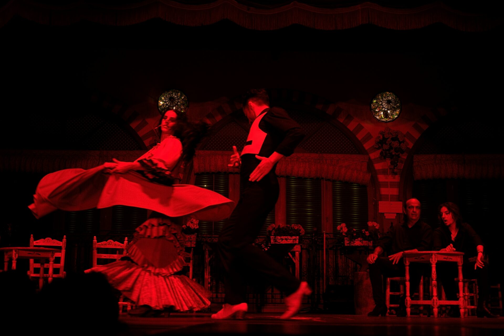 A flamenco show bathed in red lights
