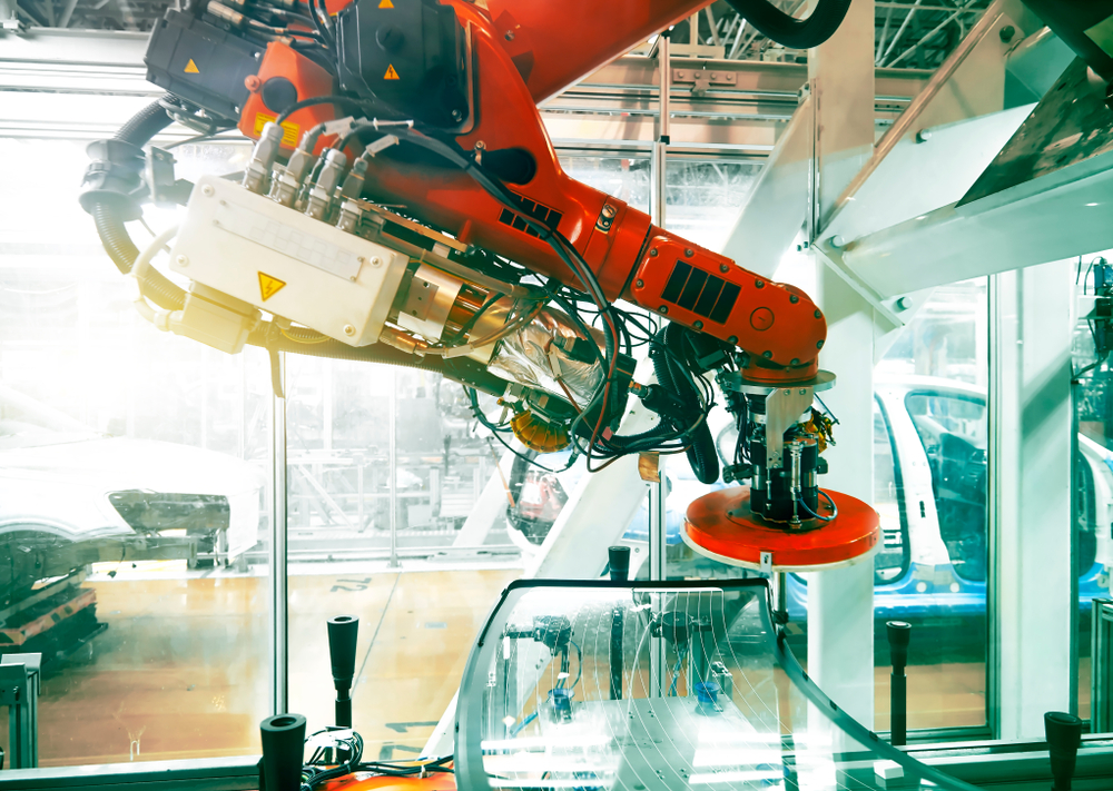 An automotive manufacturing machine's red arm