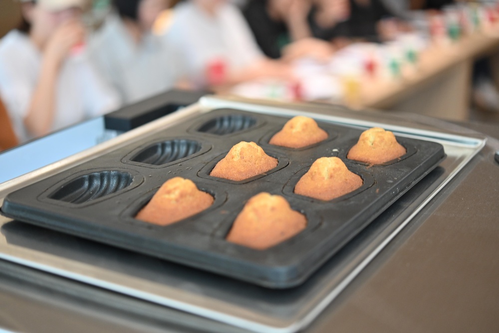 Madeleines in a cooking tray fresh out of the oven at a pastry workshop