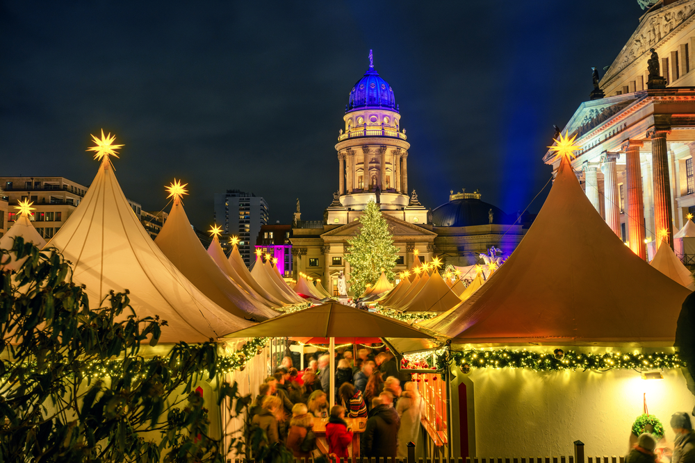 Christmas market with the French Church and Konzerthaus in Berlin at night