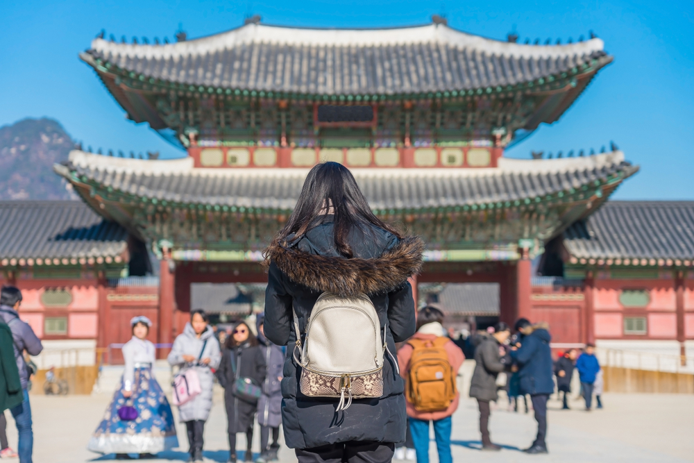 Student standing in front of Gyeongbokgung Palace in Seoul