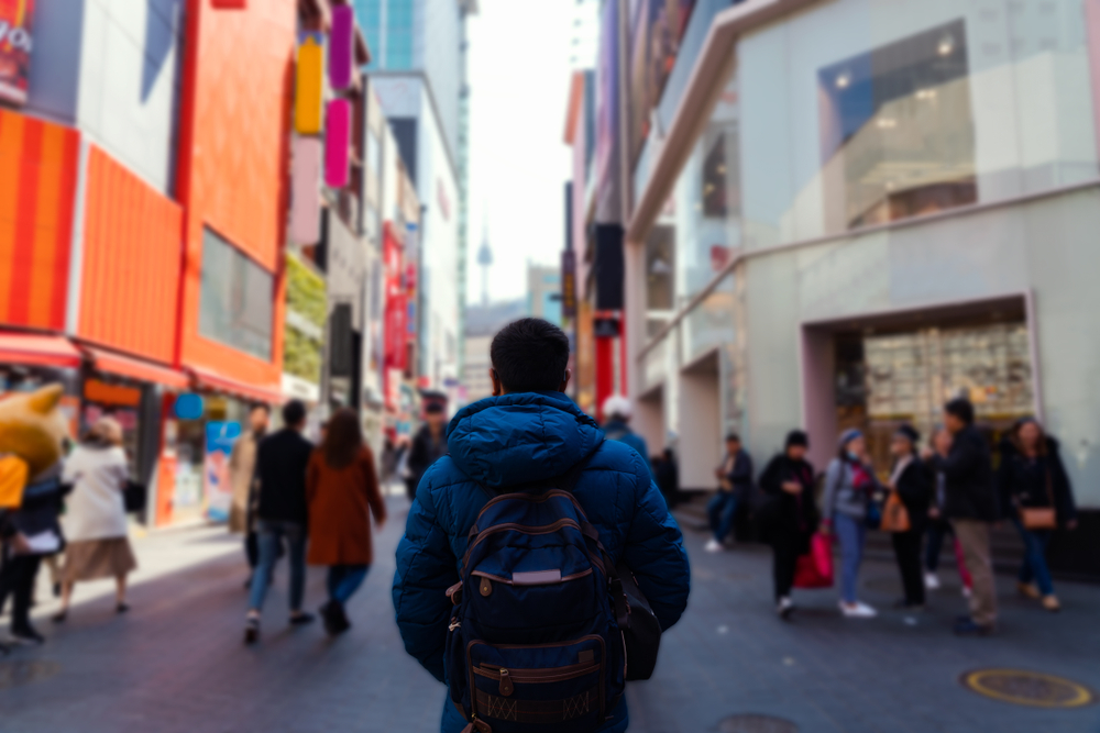 Student walking down a street in Myeongdong neighbourhood